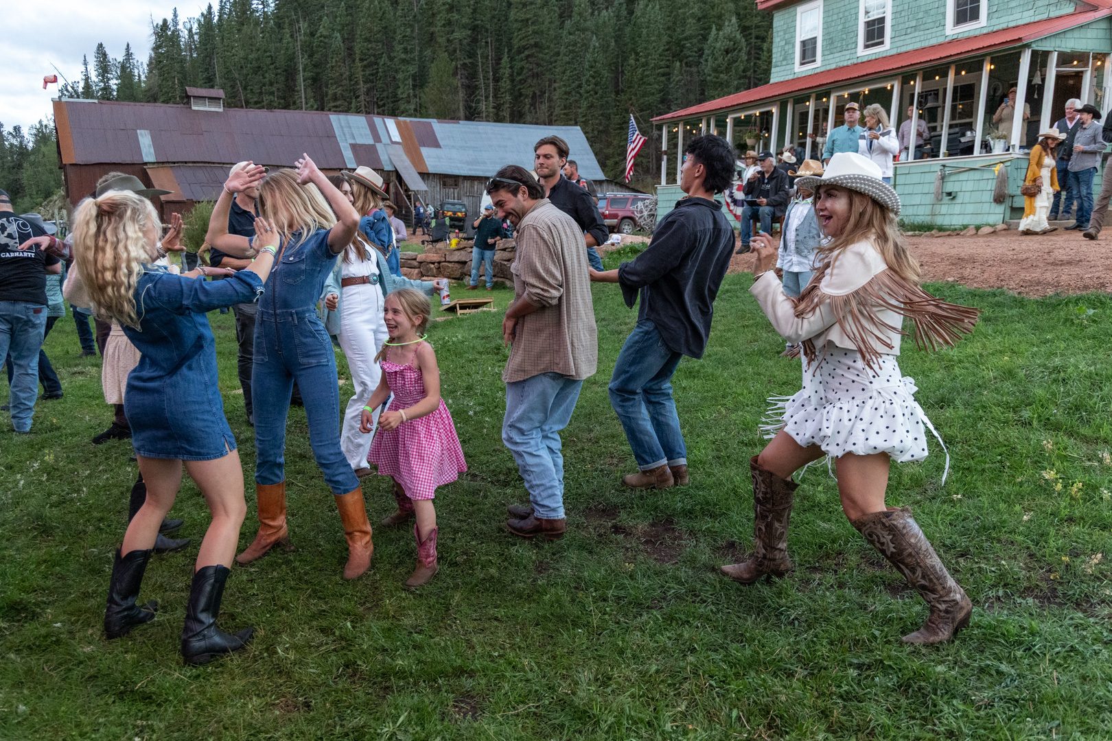 Guests dancing on the lodge lawn at the August barn dance