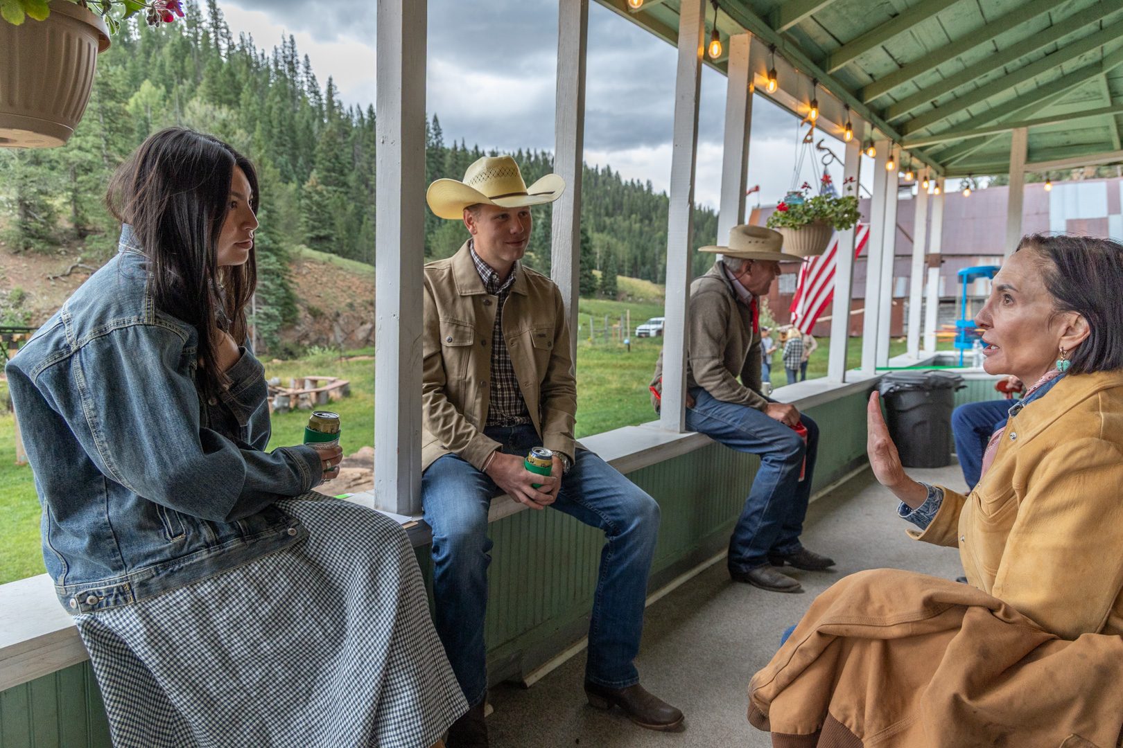 Guests visiting on the lodge porch on a summer afternoon