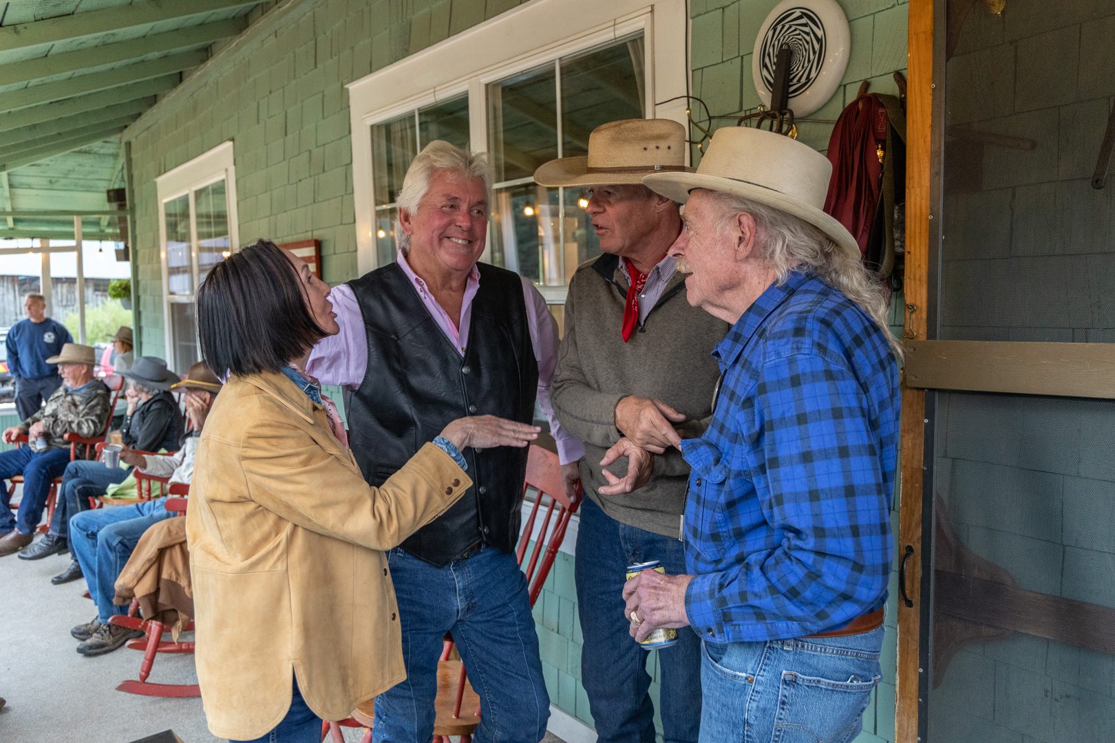 Guests trading stories on the lodge porch