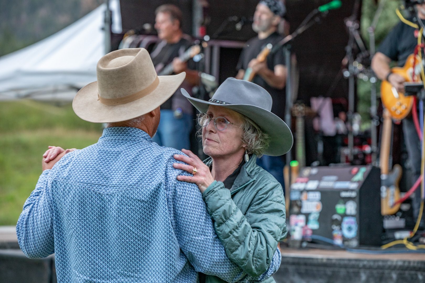 A couple slow dancing by the stage at the August barn dance