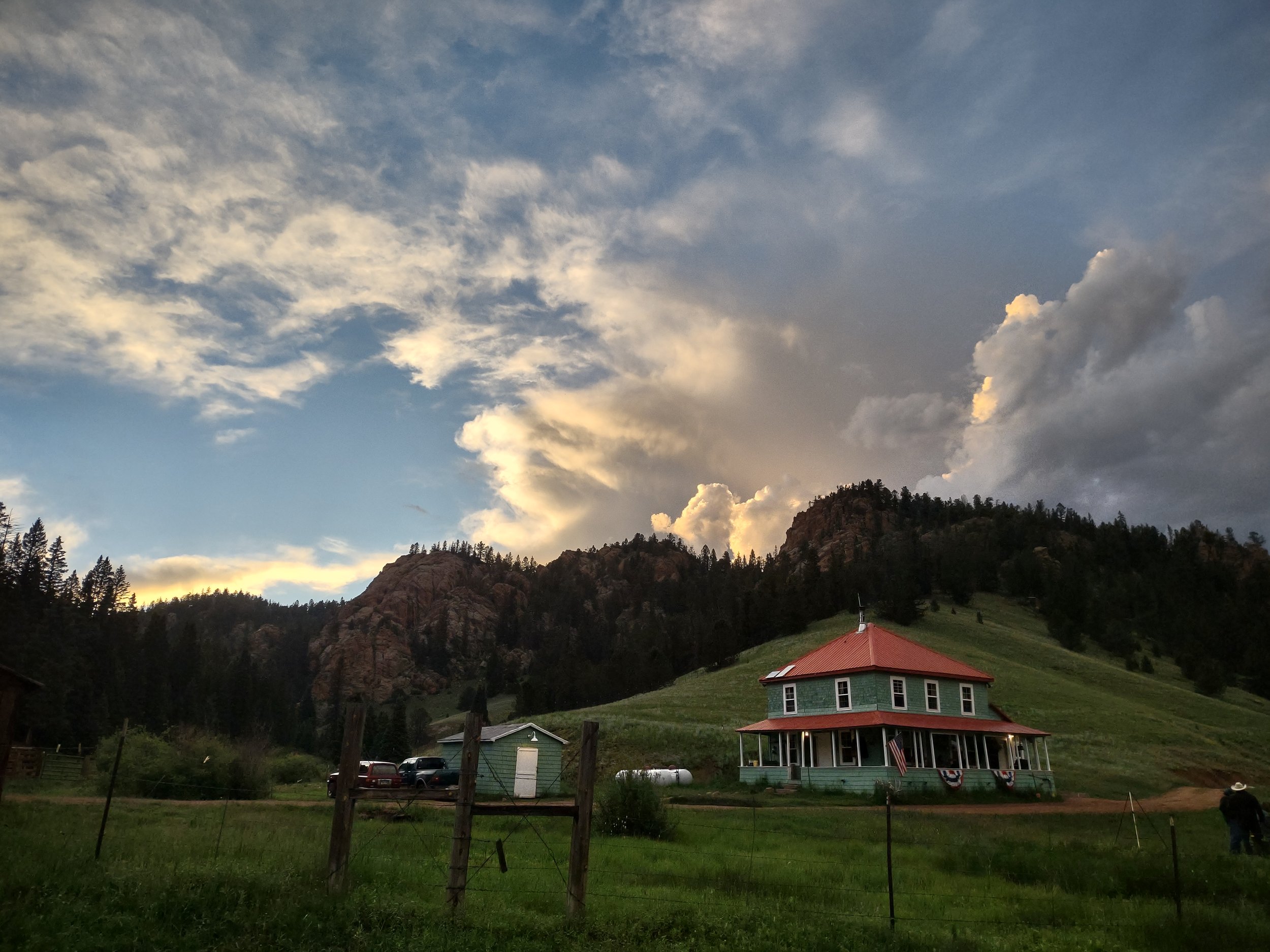 The Elk Glade lodge at sunset under a building thunderhead