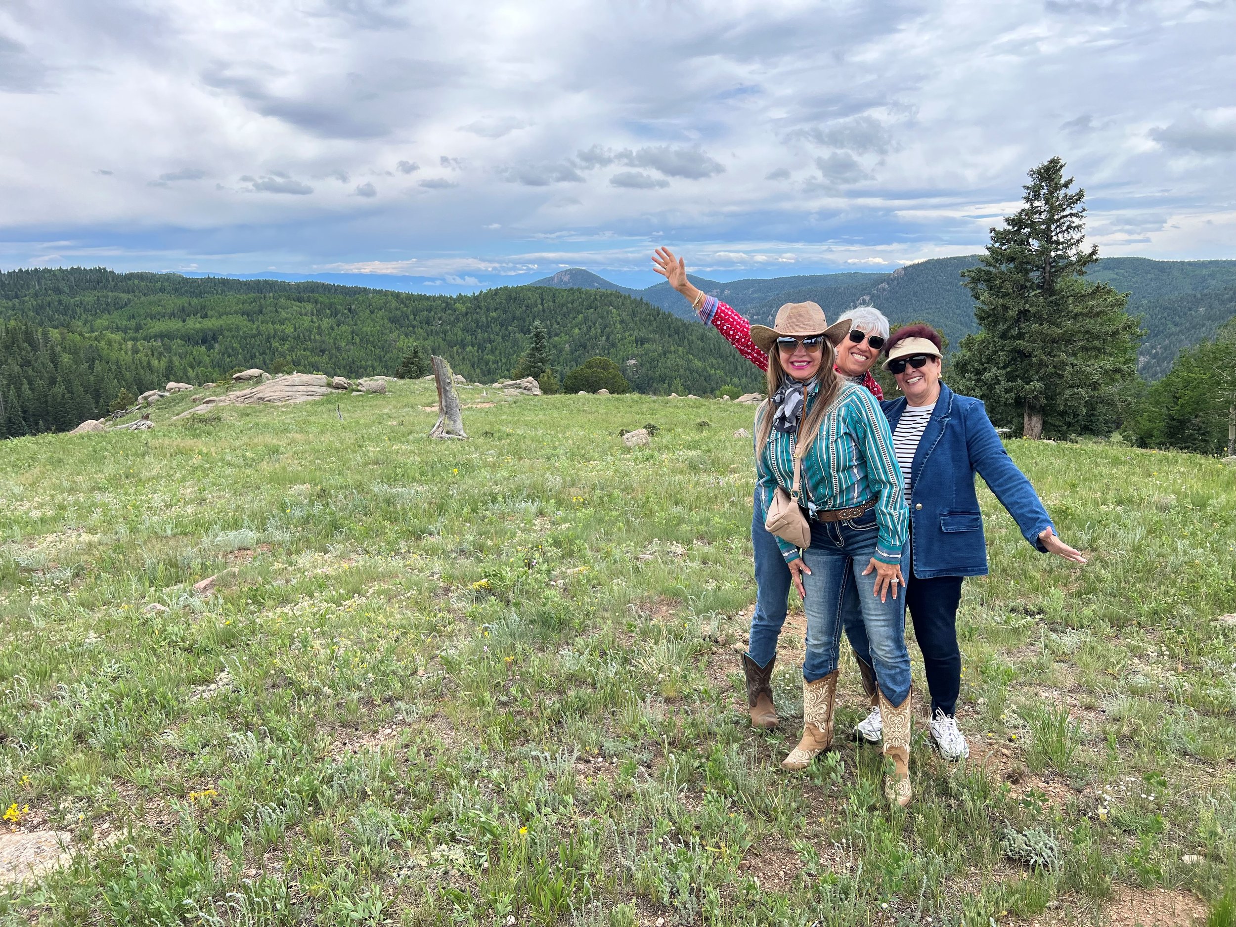 Three friends taking in the view from a high meadow on the ranch